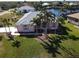Aerial view of single-Gathering home with palm trees and canal views at 649 Maltese Dr, Punta Gorda, FL 33950