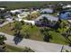 Aerial view of a charming single-Gathering home with a manicured lawn and beautiful landscaping at 649 Maltese Dr, Punta Gorda, FL 33950