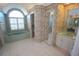 Bathroom featuring a large window and soaking tub, white tile flooring, and colorful wallpaper at 649 Maltese Dr, Punta Gorda, FL 33950