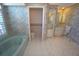 Bathroom featuring a soaking tub, toilet, and vanity with mirror, all with patterned wallpaper at 649 Maltese Dr, Punta Gorda, FL 33950