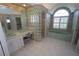A bathroom featuring a vanity with a mirror, a block glass shower, and a large window above a tub at 649 Maltese Dr, Punta Gorda, FL 33950