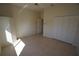 This bedroom features ample closet space, a ceiling fan, and tile flooring at 649 Maltese Dr, Punta Gorda, FL 33950