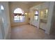 Elegant dining room featuring a large window, decorative chandelier, and built-in display cabinets at 649 Maltese Dr, Punta Gorda, FL 33950