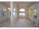 Inviting foyer with tile flooring, arched doorways, and built-in cabinets at 649 Maltese Dr, Punta Gorda, FL 33950