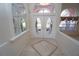 Inviting foyer featuring decorative tile inlay, etched glass door, arched windows, and transom windows at 649 Maltese Dr, Punta Gorda, FL 33950