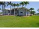 Desirable home with palm trees, picturesque landscaping, and an inviting entrance with a manicured lawn at 649 Maltese Dr, Punta Gorda, FL 33950