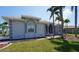 Beautiful single-story home featuring an arched entryway and lush landscaping with mature palm trees at 649 Maltese Dr, Punta Gorda, FL 33950