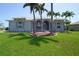 Charming single-story home with a landscaped front yard and beautiful curb appeal and mature palm trees at 649 Maltese Dr, Punta Gorda, FL 33950