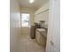 Well-lit laundry room featuring modern washer and dryer at 649 Maltese Dr, Punta Gorda, FL 33950