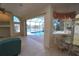 Living room showcasing sliding doors leading to a screened-in pool and waterfront view at 649 Maltese Dr, Punta Gorda, FL 33950