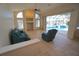 Bright living room featuring a fireplace and sliding doors to a screened-in pool at 649 Maltese Dr, Punta Gorda, FL 33950