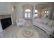 Inviting living room with a fireplace, and ample seating with a view into the dining room at 649 Maltese Dr, Punta Gorda, FL 33950