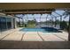 View of screened lanai, pool and hot tub with water view beyond at 649 Maltese Dr, Punta Gorda, FL 33950