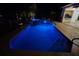 Night view of private swimming pool and integrated hot tub with blue lights at 649 Maltese Dr, Punta Gorda, FL 33950