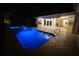 The bright blue pool and patio, lit at night, create a peaceful backyard oasis at 649 Maltese Dr, Punta Gorda, FL 33950