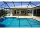 Screened in pool with hot tub and white stone patio with covered porch and outdoor kitchen at 649 Maltese Dr, Punta Gorda, FL 33950