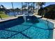 Beautiful pool with water feature and tropical landscaping at 649 Maltese Dr, Punta Gorda, FL 33950