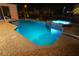 Night view of private swimming pool and integrated hot tub with blue lights at 649 Maltese Dr, Punta Gorda, FL 33950
