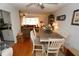 Bright dining area with a large wooden table and six chairs, situated between the kitchen and living room at 726 Macedonia Dr, Punta Gorda, FL 33950