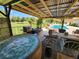 Relaxing hot tub on patio with covered seating area at 1147 Davis Ln, Englewood, FL 34224