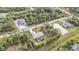 An aerial view of the home nestled on a large private lot with lush surrounding landscape at 1205 Bartlett Ave, North Port, FL 34288