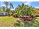 Lush backyard featuring a tropical palm tree and a screened pool at 1205 Bartlett Ave, North Port, FL 34288