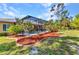 A landscaped backyard with a screened pool creates an inviting outdoor living space at 1205 Bartlett Ave, North Port, FL 34288