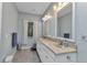 Large primary bathroom featuring double sinks, a large window, and ample counter space at 1205 Bartlett Ave, North Port, FL 34288