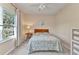 Neutral bedroom featuring a window and ceiling fan, carpeted floors and a full-sized bed at 1205 Bartlett Ave, North Port, FL 34288