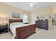 A comfortable bedroom featuring a wooden bed frame and dresser, with neutral wall color and carpeted floor at 1205 Bartlett Ave, North Port, FL 34288