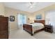 Cozy bedroom with wood furnishings, a ceiling fan, and natural light at 1205 Bartlett Ave, North Port, FL 34288