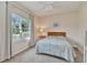 Cozy bedroom with natural light from the large window overlooking the landscaped yard at 1205 Bartlett Ave, North Port, FL 34288