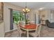 Comfortable dining room with natural light, tile floors, and modern decor, ideal for Gathering meals at 1205 Bartlett Ave, North Port, FL 34288