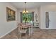 Cozy dining room with a wooden table set, large windows, and stylish decor creating an inviting space at 1205 Bartlett Ave, North Port, FL 34288