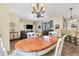 Open floor plan of a dining room with view into living room and kitchen bar seating at 1205 Bartlett Ave, North Port, FL 34288