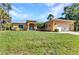 Inviting single-story home featuring a well-manicured lawn, attached garage, and charming curb appeal at 1205 Bartlett Ave, North Port, FL 34288