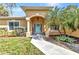 Charming home with a beautifully landscaped front yard and inviting light-blue front door with decorative wreath at 1205 Bartlett Ave, North Port, FL 34288