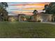 Inviting single Gathering home with a spacious lawn and driveway at sunset at 1205 Bartlett Ave, North Port, FL 34288