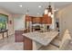 Kitchen boasts granite counters, stainless appliances, wood cabinets, tile flooring, and pendant lighting at 1205 Bartlett Ave, North Port, FL 34288