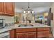 Kitchen featuring granite countertops, tile backsplash, stainless sink, pendant lighting, and eat in bar at 1205 Bartlett Ave, North Port, FL 34288