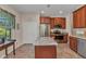 Eat-in kitchen boasts stainless steel appliances, granite countertops, and wood cabinets at 1205 Bartlett Ave, North Port, FL 34288