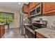 Galley kitchen with stainless steel appliances and granite countertops at 1205 Bartlett Ave, North Port, FL 34288