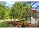 Beautiful tropical landscaping and a covered outdoor dining/entertaining area at 1205 Bartlett Ave, North Port, FL 34288