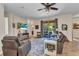 Spacious living room with comfortable seating, tile flooring and a sliding door to outdoor living area at 1205 Bartlett Ave, North Port, FL 34288