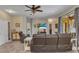 Relax in this living room, with reclining leather sofa, ceiling fan, and sliding glass door to patio at 1205 Bartlett Ave, North Port, FL 34288