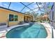 Relaxing backyard pool with screened enclosure, offering a private oasis for outdoor enjoyment and entertaining at 1205 Bartlett Ave, North Port, FL 34288