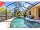 Relaxing screened-in pool area with lush landscaping offering a private backyard oasis at 1205 Bartlett Ave, North Port, FL 34288