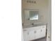 Bathroom featuring white vanity, large mirror, and ample counter space at 12090 Malaga Ave, North Port, FL 34287