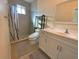 Modern bathroom with a walk-in shower, white vanity, and updated fixtures at 12090 Malaga Ave, North Port, FL 34287