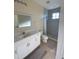 Clean bathroom with white vanity, shower, and tile flooring at 12090 Malaga Ave, North Port, FL 34287